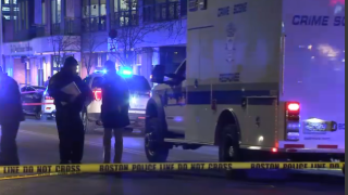 Police investigate the scene of a fatal shooting on Wednesday, Jan. 22, 2020 in Boston's Dorchester neighborhood.