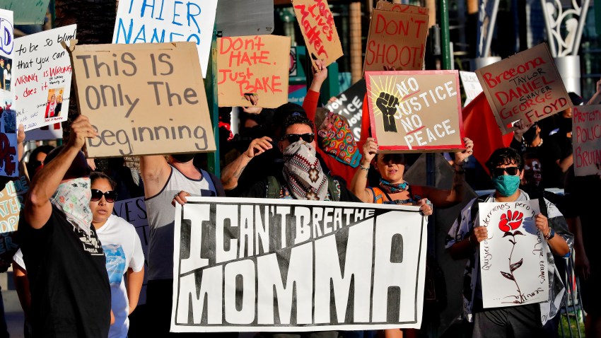 Protesters rally Tuesday, June 9, 2020, in Mesa, Ariz. demanding police reform. The protest was prompted by the death of George Floyd, a black man who died after being restrained by Minneapolis police officers May 25.