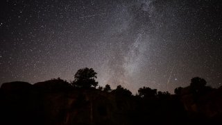 Perseid meteors streak across the night sky over the ancient city of Mesotimolos in Esme district of Turkey's western Usak province on August 13, 2019.