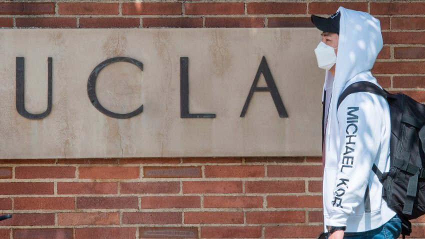 File Image: A student wears a face mask to protect against the COVID-19 (Coronavirus) as he leaves the campus of the UCLA college in Westwood, California on March 6, 2020.