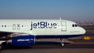 A JetBlue passenger jet taxis at LaGuardia Airport in New York