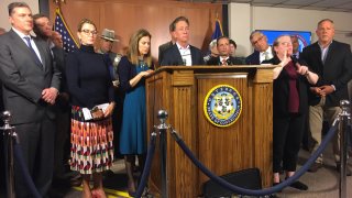 Governor Ned Lamont at podium as he declares public health emergency