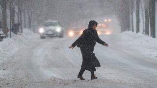 Woman walking through snowy street