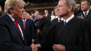 U.S. President Donald Trump shakes hands with Supreme Court Chief Justice John Roberts before the State of the Union address in the House chamber on February 4, 2020 in Washington, DC.