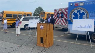 The mayor of Revere, Massachusetts, speaks about the coronavirus pandemic in front of ambulances.