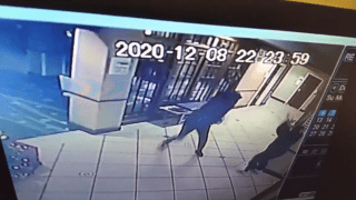 A still from surveillance video showing a man throw a vase at a hotel worker in Manchester, New Hampshire