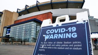 A COVID-19 warning and prevention message is seen outside Gillette Stadium before a game between the New England Patriots and the New York Jets on Sunday, Jan. 3, 2021.