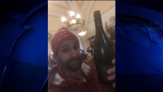 Jason Riddle drinking wine at the Capitol