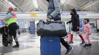 Travelers arrive for flights at O'Hare international Airport