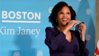 Kim Janey removes her face mask to speak after she was sworn in as Boston's new mayor at City Hall, March 24, 2021, in Boston.