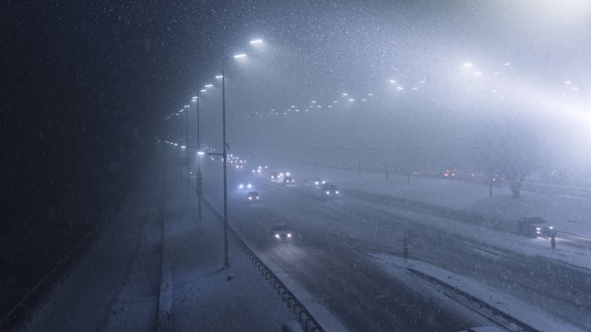 Top view of Heavy snowfall on the motorway at night, difficult weather conditions will create problems with movement in the city during heavy snowfall