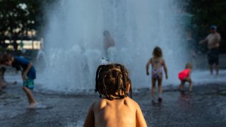 Niños juegan en un parque en medio de la ola de calor en Portland, Oregon.