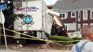 A truck crashed into a Winthrop, Massachusetts, building on Saturday. The driver fatally shot two people before being killed by police, authorities said.