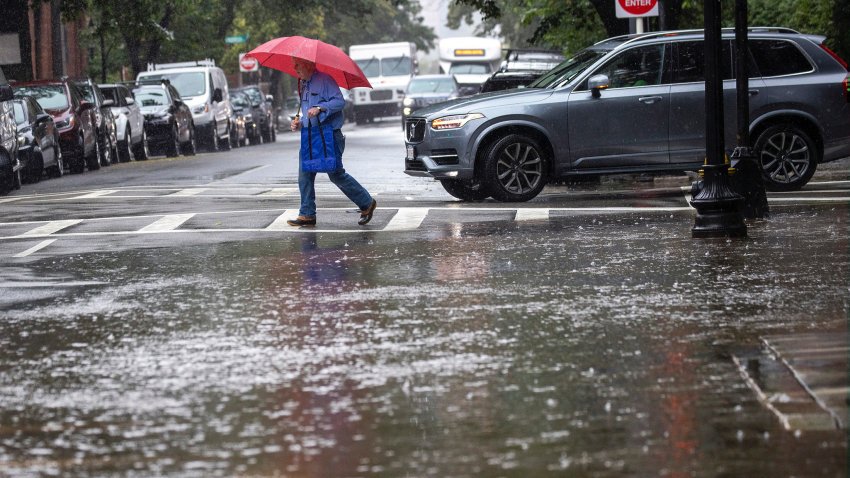 A huge puddle almost takes over the crosswalk