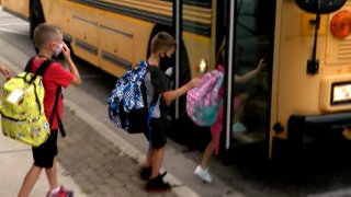 Children board a school bus