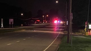 A police car is parked in the distance.