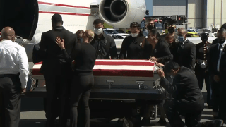 The family of fallen Marine Sgt. Johanny Rosario Pichardo greets her casket at Boston Logan International Airport on Saturday, Sept. 11, 2021.