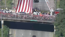 People pay respects as the casket of Marine Sgt. Johanny Rosario Pichardo is driven home to Lawrence, Massachusetts. She was killed in a suicide bombing at the airport in Kabul, Afghanistan.