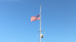 The American flag at half-staff during a 9/11 memorial ceremony in Boston on Saturday, Sept. 11, 2021.