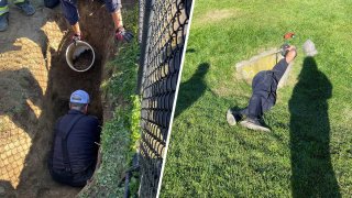 Firefighters rescuing a dog trapped in a West Roxbury storm drain on Wednesday, Oct. 13, 2021.