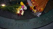 Boston - October 11: Bouquets of flowers rest at the foot of the Boston Marathon Bombing Memorial at the Finish Line of the 125th Boston Marathon in Boston on Oct. 11, 2021. (Photo by Jessica Rinaldi/The Boston Globe via Getty Images)