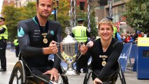 BOSTON, MASSACHUSETTS - OCTOBER 11: Marcel Hug and Manuela Schar of Switzerland pose with the Champion's Trophy after winning the men's and women's wheelchair races during the 125th Boston Marathon on October 11, 2021 in Boston, Massachusetts. (Photo by Maddie Meyer/Getty Images)