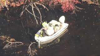 Divers searching the Concord River on Wednesday, Nov. 3, 2021.
