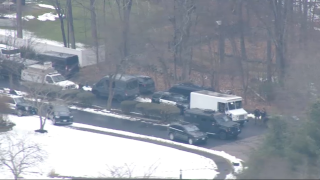 Police at the scene of a standoff with a barricaded person in Foxboro, Massachusetts, on Friday, Jan. 14, 2022.