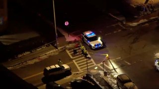 a sky view of a police cruiser and tape over an intersection