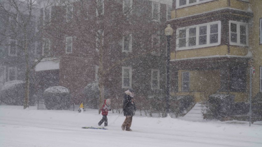 Resident walk down a street during a blizzard in Boston, Massachusetts, U.S., on Saturday, Jan. 29, 2022. A powerful winter storm is whipping the U.S. Northeast with high winds, crashing surf, and quickly piling up snow on the country’s major transportation routes, while canceling flights and leaving thousands without power. Photographer: Allison Dinner/Bloomberg via Getty Images