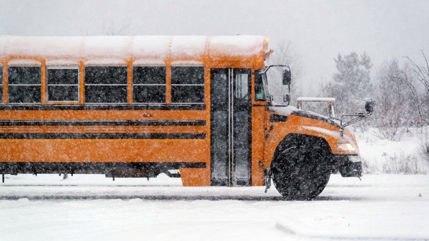 In this file photo, a school bus driver navigates a highway during heavy snow.