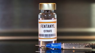 A file photo of a bottle labeled "fentanyl citrate" next to a syringe