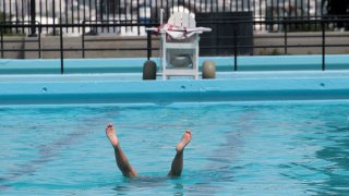 This 2016 file photo shows someone in the water at BCYF Clougherty Pool in Boston's Charlestown neighborhood.