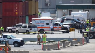 Safety officials at the Conley Container Terminal in Boston on Wednesday, June 15, 2022, after a person hit by a truck died.