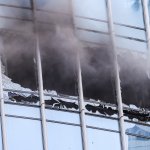 Smoke pours from blown-out windows in a Boston high-rise Friday, June 24, 2022.