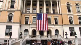 An American flag hanging on the Massachusetts State House on Sept. 11, 2022.