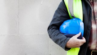 Builder holding a hard hat