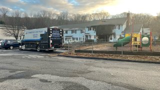 Officials at the scene of a fatal fire at Moosup Gardens Apartments on November 17 2022