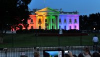 People take photos of the White House lightened in the rainbow colors in Washington on June 26. 2015. The US Supreme Court ruled Friday that gay marriage is a nationwide right, a landmark decision in one of the most keenly awaited announcements in decades and sparking scenes of jubilation. AFP PHOTO/MLADEN ANTONOV        (Photo credit should read MLADEN ANTONOV/AFP via Getty Images)