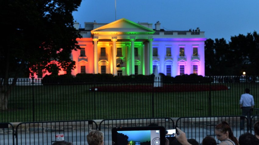 People take photos of the White House lightened in the rainbow colors in Washington on June 26. 2015. The US Supreme Court ruled Friday that gay marriage is a nationwide right, a landmark decision in one of the most keenly awaited announcements in decades and sparking scenes of jubilation. AFP PHOTO/MLADEN ANTONOV        (Photo credit should read MLADEN ANTONOV/AFP via Getty Images)