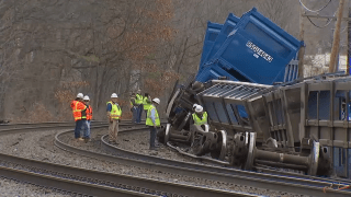 Freight train cars pictured toppled over in Ayer