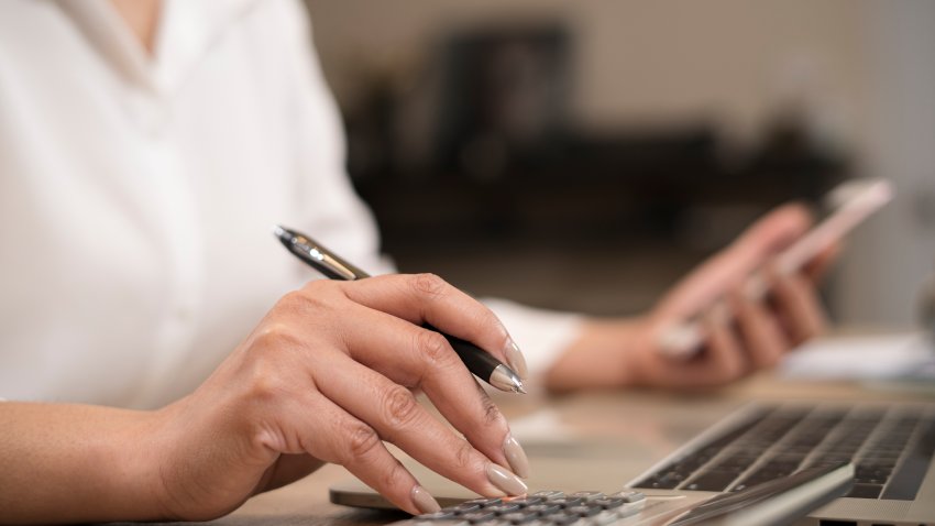 Finances and economy concept.Close up hand of business woman accountant or banker making calculations.