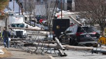 Seven utility poles carrying power lines fell along a street in Stoneham, Massachusetts, on Wednesday, March 1, 2023.