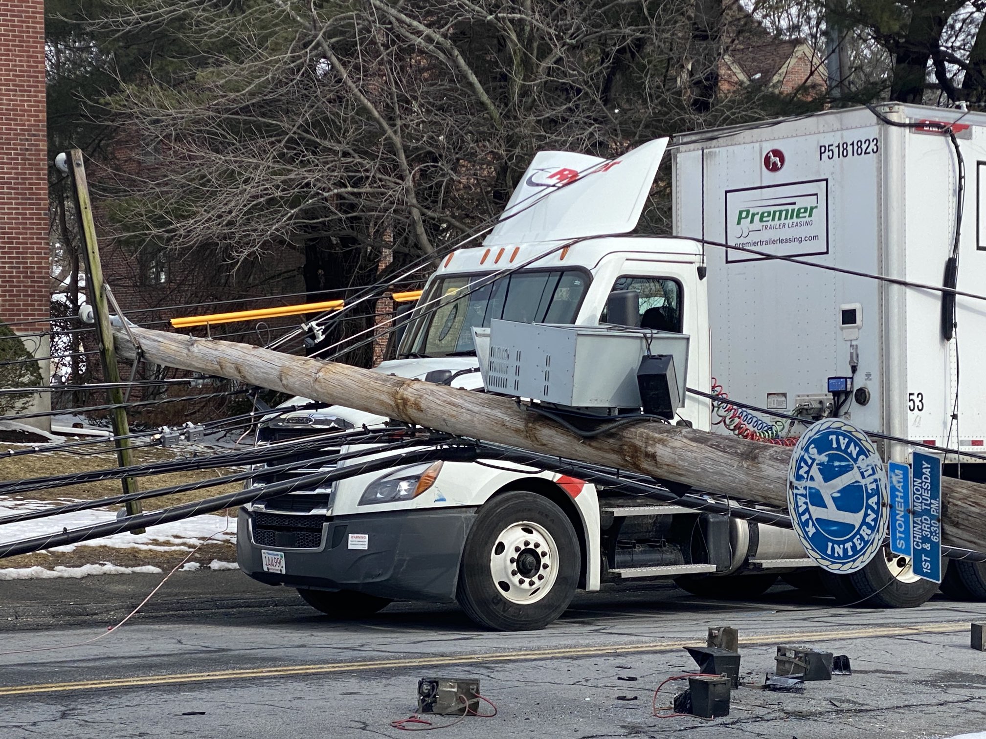 Seven utility poles carrying power lines fell along a street in Stoneham, Massachusetts, on Wednesday, March 1, 2023.