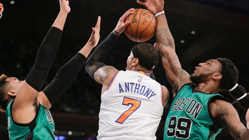 New York Knicks forward Carmelo Anthony (7) is double teamed while shooting against Boston Celtics center Jared Sullinger, left, and forward Jae Crowder (99) during the first quarter of an NBA basketball game, Tuesday, Feb. 2, 2016, in New York. (AP Photo/Julie Jacobson)