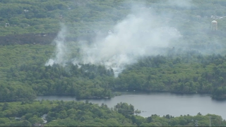 Smoke rising from a brush fire in Lynn, Massachusetts, on Monday, May 15, 2023.