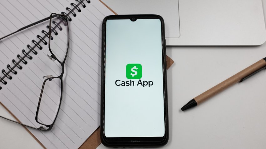 In this photo illustration a Cash App logo is displayed on a smartphone screen above a notebook next to glasses and a pen in Athens, Greece on June 22, 2023.