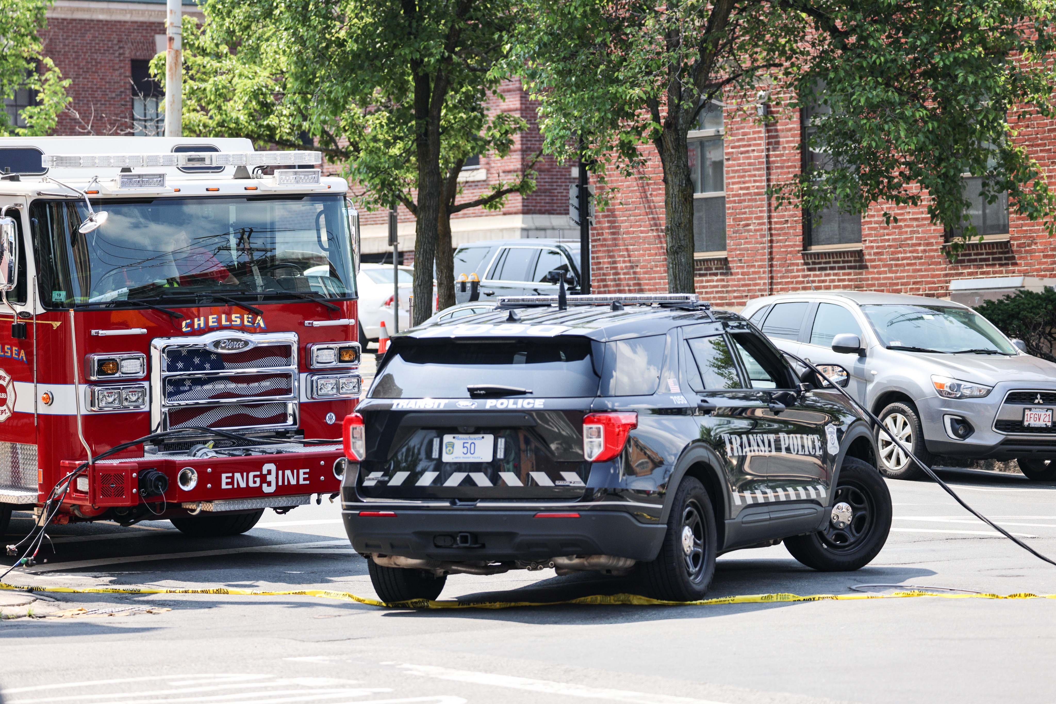 A downed power line across several vehicles near city hall in Chelsea, Massachusetts, on Friday, June 16, 2023.
