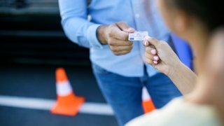 Driving student receiving her licence