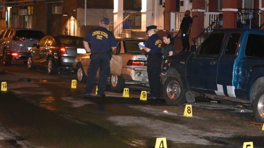 Yellow evidence markers and police investigators